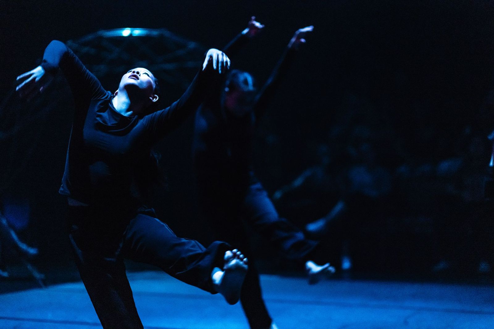 Dancers perform on stage.