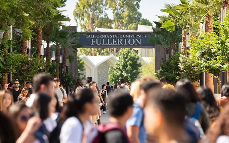 CSUF Promenade signage framed by students