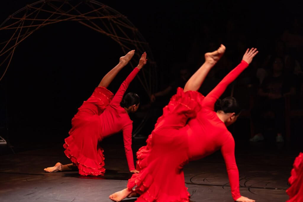 Dancers perform on stage. 