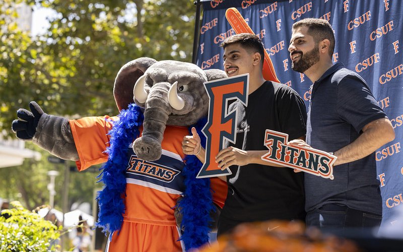 Two students pose for a picture with Tuffy.