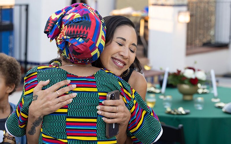 Mei Ling Malone hugs Gwendolyn Alexis.