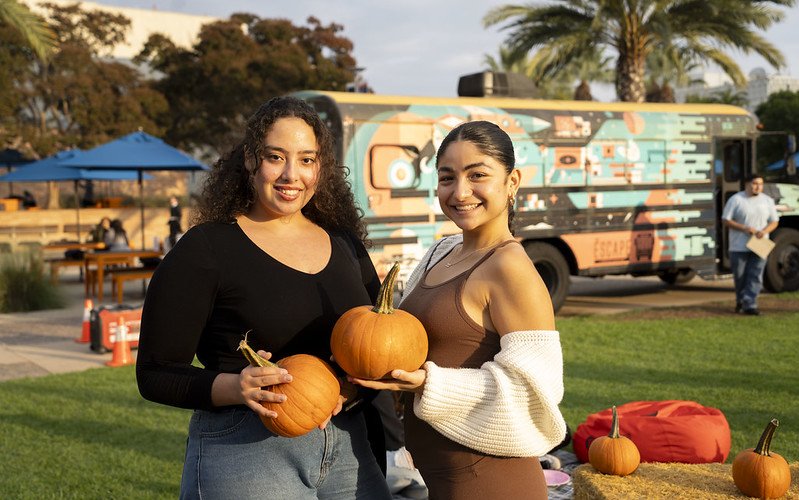 Two students hold pumpkins during the ASI Pumpkin Patch event in 2024.