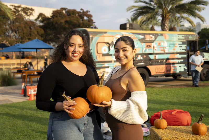 Two students hold pumpkins during the ASI Pumpkin Patch event in 2024.