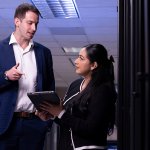 Carlos Yebra López and Michelle Ramirez speak in server room