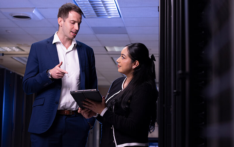 Carlos Yebra López and Michelle Ramirez speak in server room