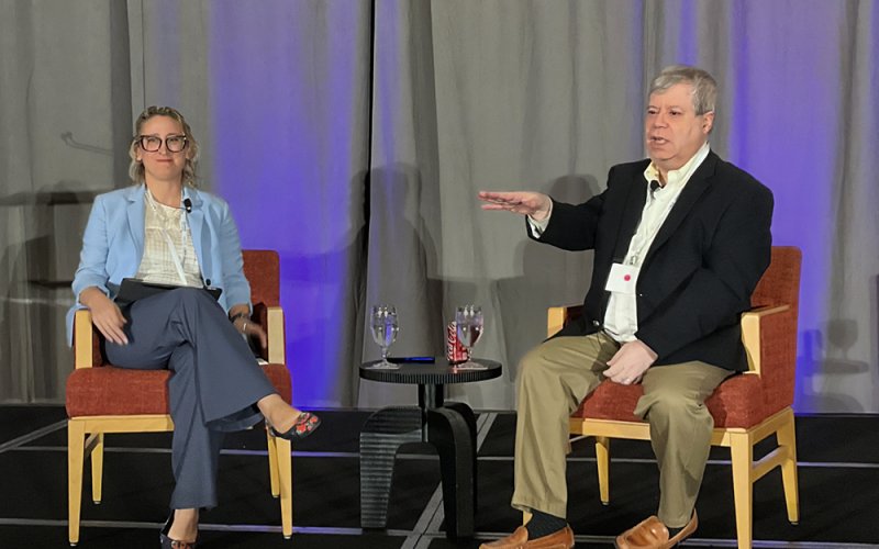 Keynote presenter Brian Lane and moderator Lauren Assaf-Holmes present at the annual SEC “Hot Topics” Conference.