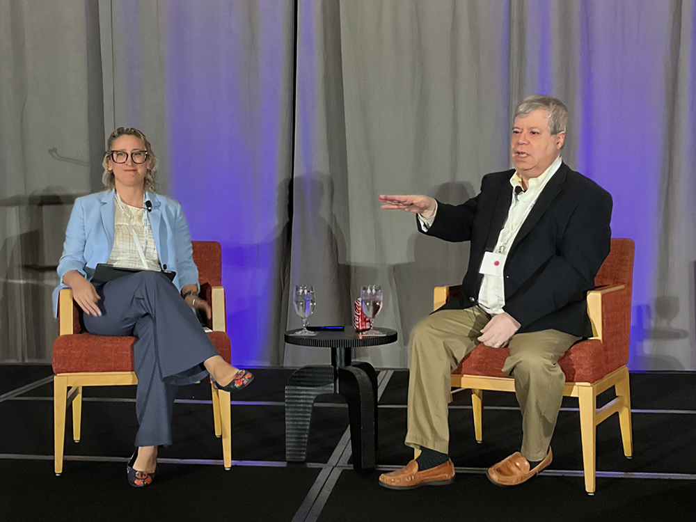 Keynote presenter Brian Lane and moderator Lauren Assaf-Holmes present at the annual SEC “Hot Topics” Conference.