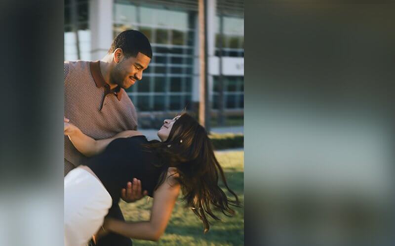 Two students dance outside of the Student Recreation Center.
