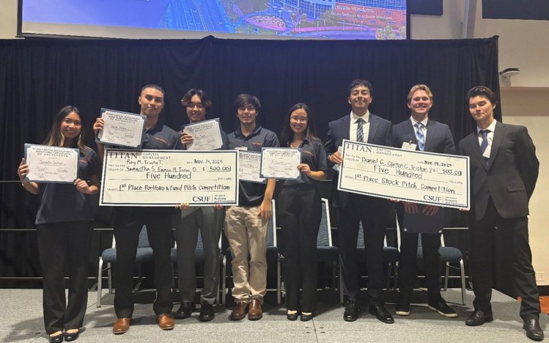 A group of CSUF students hold certificates and smile at the 2025 Student Investment Conference.