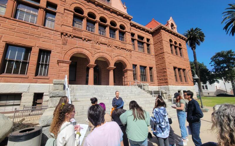 A group of college students learns about the old Orange County courthouse.