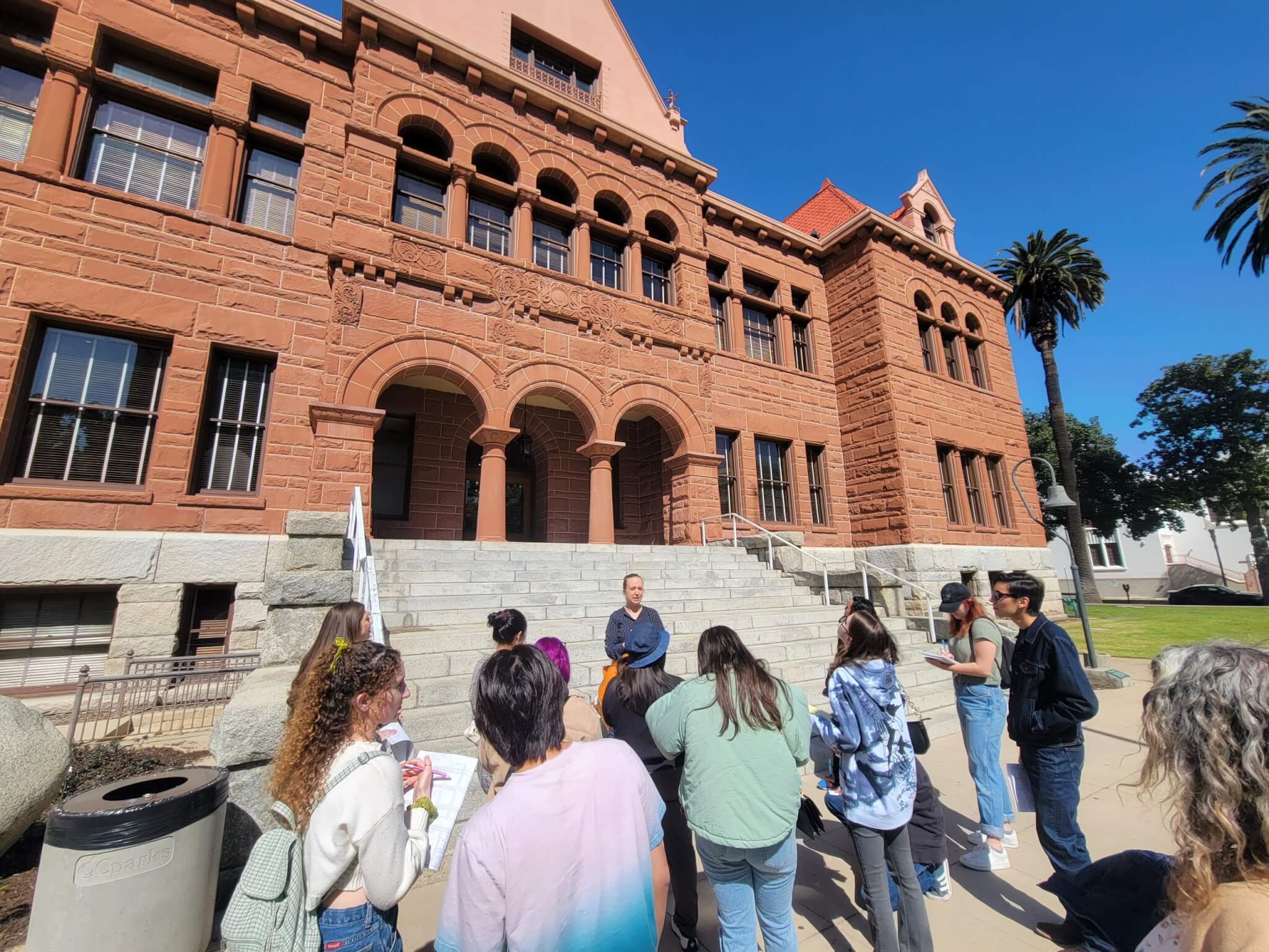 A group of college students learns about the old Orange County courthouse.