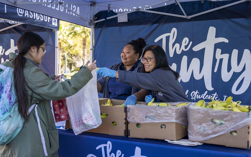 Student receives bananas at ASI Pop-Up Pantry event in the Quad.