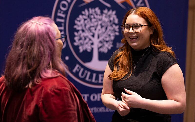 Student Cailin Scheussler talks with Professor of Public Health Michele Wood