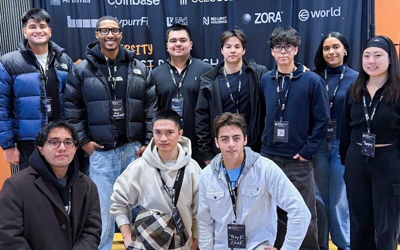 Members of the Titan Blockchain club smile for a group photo.