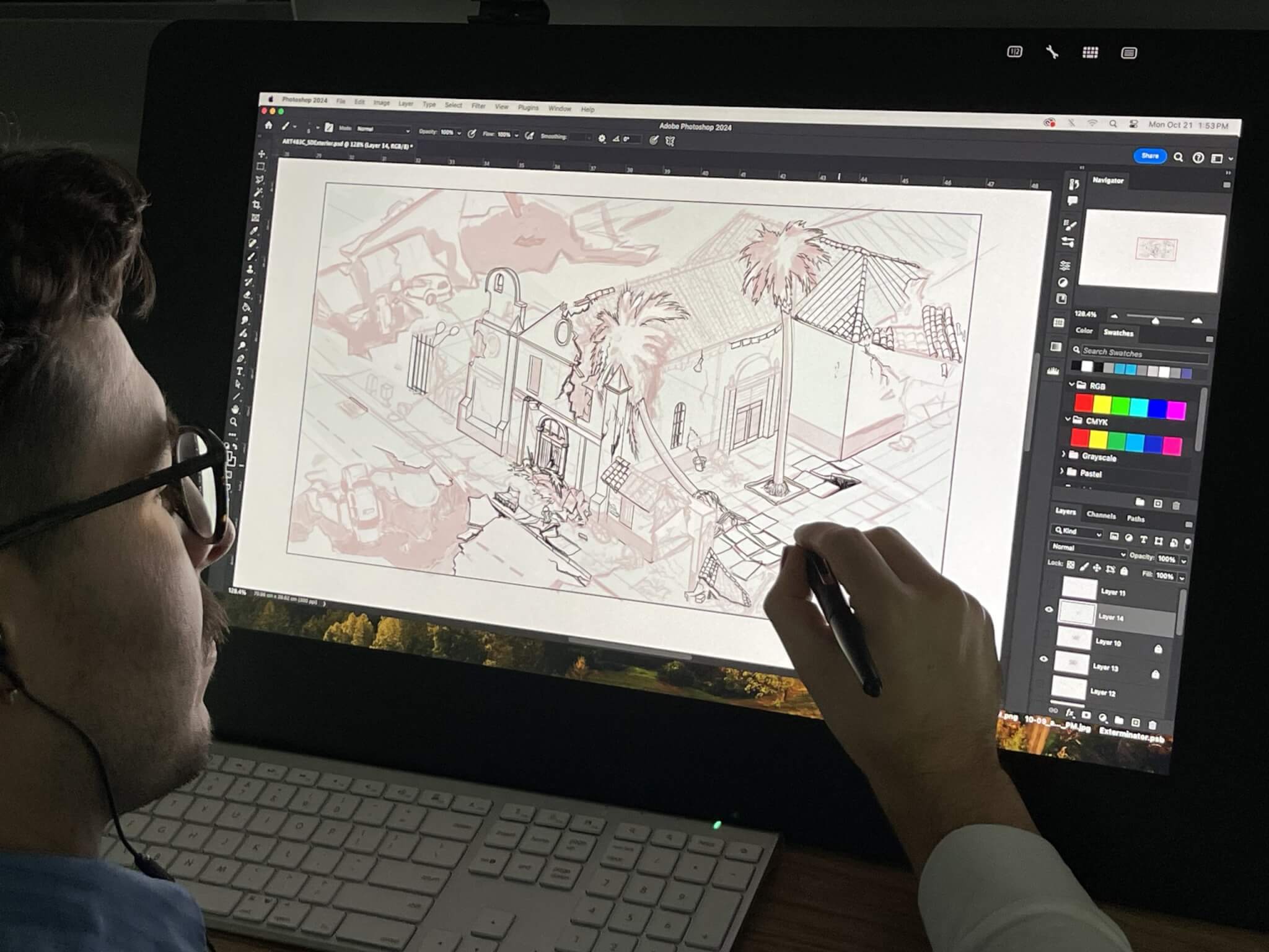 A student in a dark room works on a concept design on a large computer screen