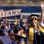 Student waves at commencement