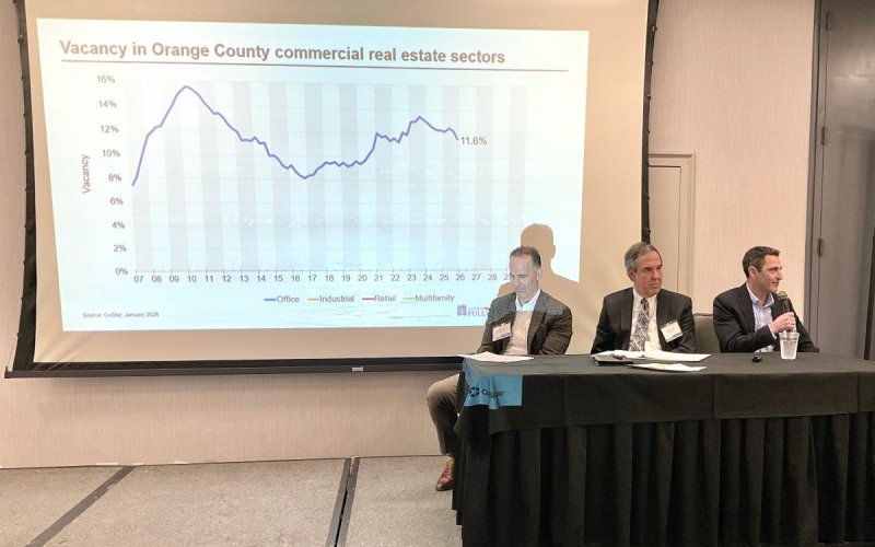 Three industry experts present a slideshow during a panel discussion.