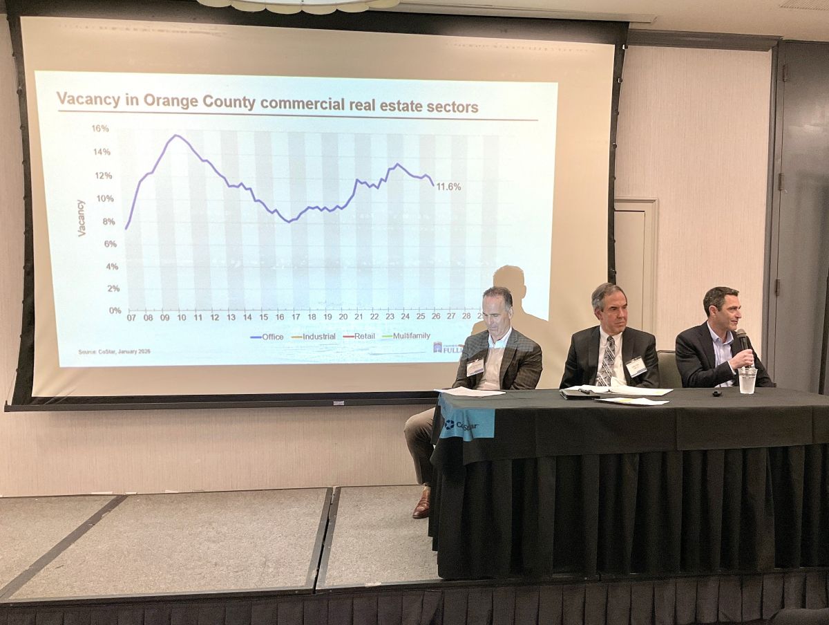 Three industry experts present a slideshow during a panel discussion.
