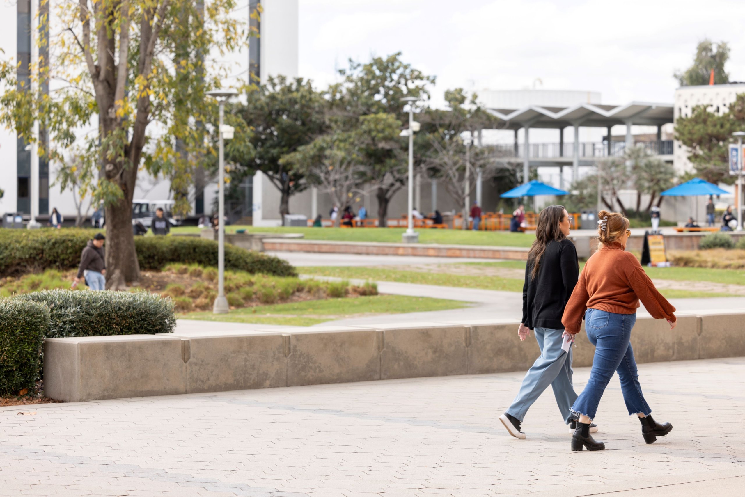 Two people walk on the Cal State Fullerton campus