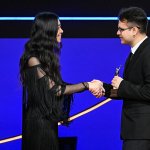 CSUF student Luis Barragan accepts the Anne V. Coates Award for Student Editing and shakes hands with Chloe Zhao, director and filmmaker