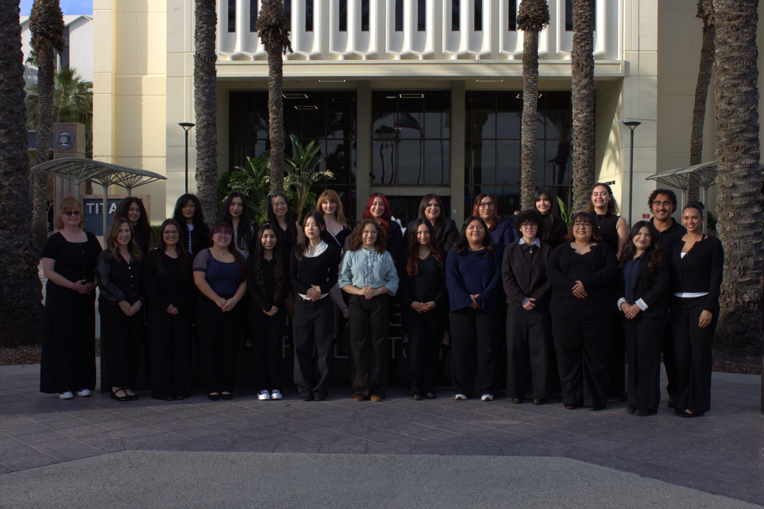 Comm Week student team poses for a group photo outside of Langsdorf Hall.