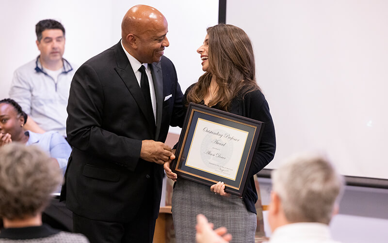 CSUF President Ronald Rochon congratulates Allison Dover at the April 23 Academic Senate meeting.