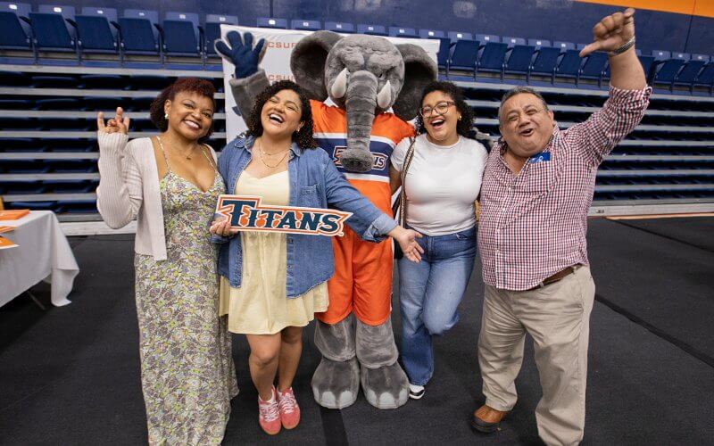 Maricielo Mejia celebrates her acceptance to CSUF with Tuffy and her family.
