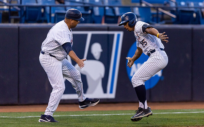 Titans Baseball player Paul Contreras high-fives his coach