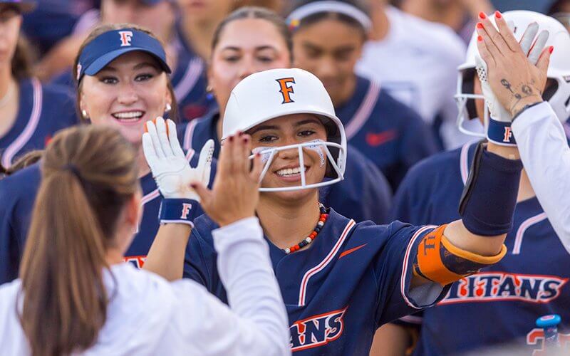Alexia Lopez high fives her Titans Softball teammates