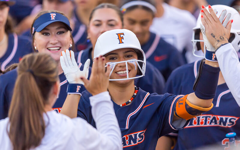 Alexia Lopez high fives her Titans Softball teammates