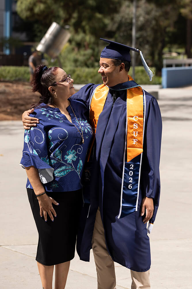 Class of 2026 grad Kevin Greene hugs his mother