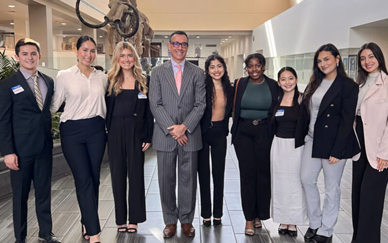 Jake Beniflah, lecturer in marketing, poses for a group photo with students