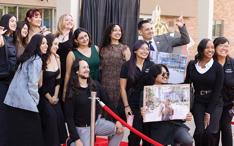 The Outreach, Recruitment and Orientation team pose on the red carpet at the 2026 University Awards Program.