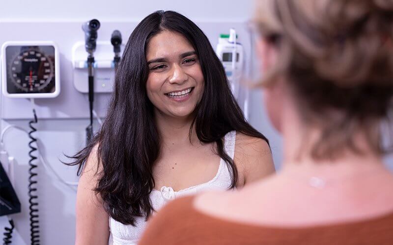 Nursing student Vicky Torres talks with a faculty member in the nursing simulation lab.
