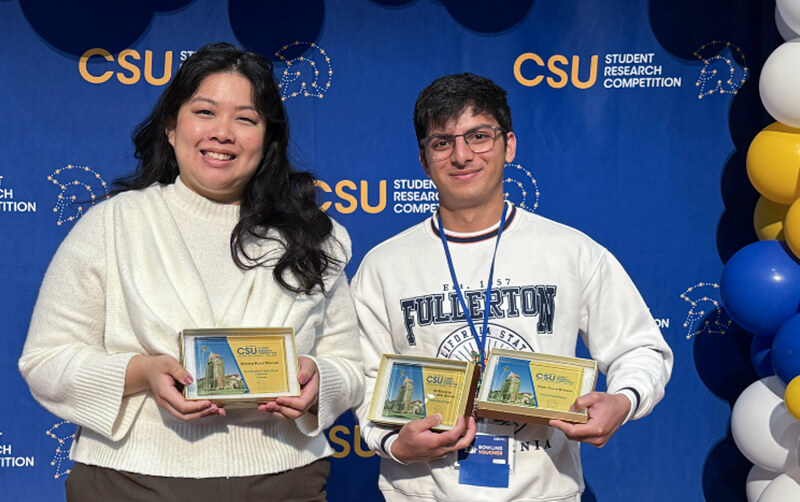 CSUF students Amanda Tsang and Kshitij Pingle hold awards at the 2026 CSU research competition.