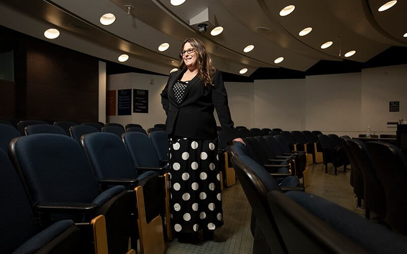 Sociology and philosophy grad Nichole Gideon poses in classroom