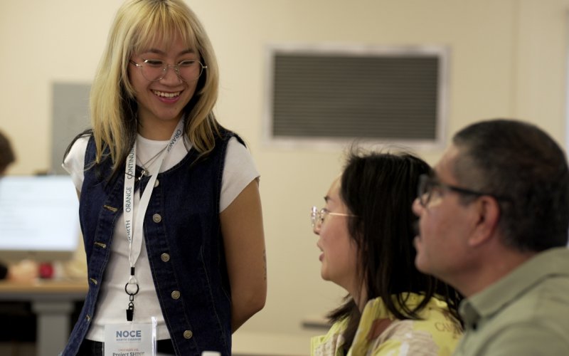 CSUF student Crystal Tran assists English language learners in a classroom.