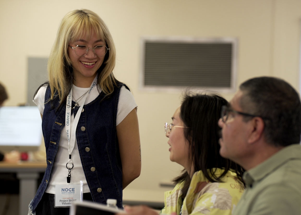 CSUF student Crystal Tran assists English language learners in a classroom.