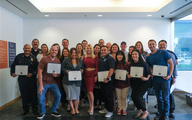 A group of students pose for a photo, holding certificates.
