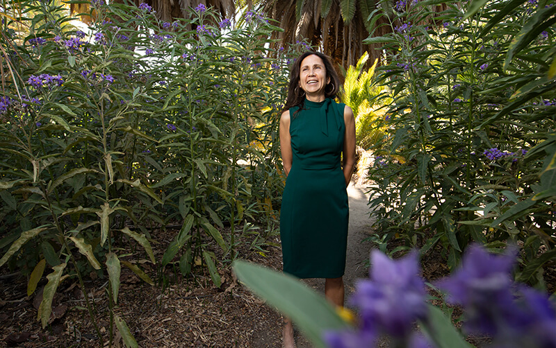 Joya Salas stands in flower field at the Arboretum and Botanical Garden at Cal State Fullerton