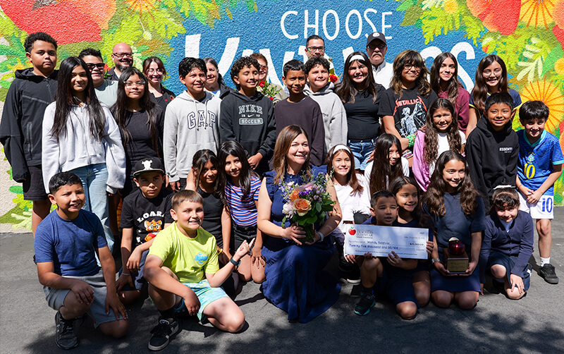 2027 Orange County Teacher of the Year Wendy Saldivar poses for a group photo with her students. 