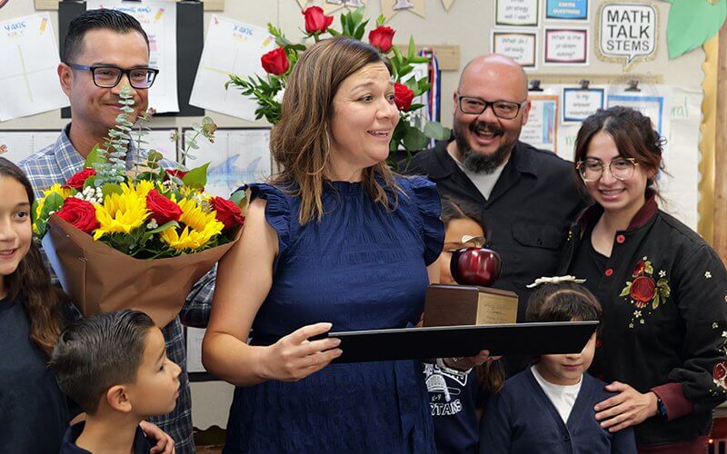 CSUF alum Wendy Saldivar receives a 2027 Orange County Teacher of the Year award in her classroom.