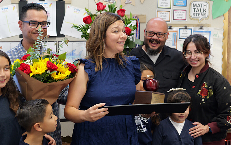CSUF alum Wendy Saldivar receives a 2027 Orange County Teacher of the Year award in her classroom.