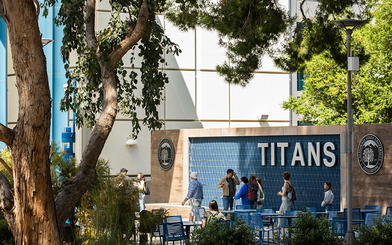 Students walk in front of the Pollak Library.