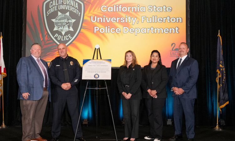 Anthony Frisbee, chief of police; Gwen Dack, administrative police services manager; and Jennifer Vallejo Rollins, CSUF PD accreditation manager and Community Service Officer program lead receive an award for IACLEA accreditation.