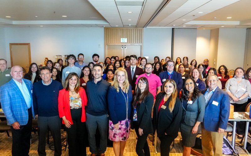 Jessica Stern, dean of the College of Humanities and Social Sciences, and Cherie Rolapp, director of the Passage to the Future program, pose for a group photo with students during Titans Reach Higher Weekend.