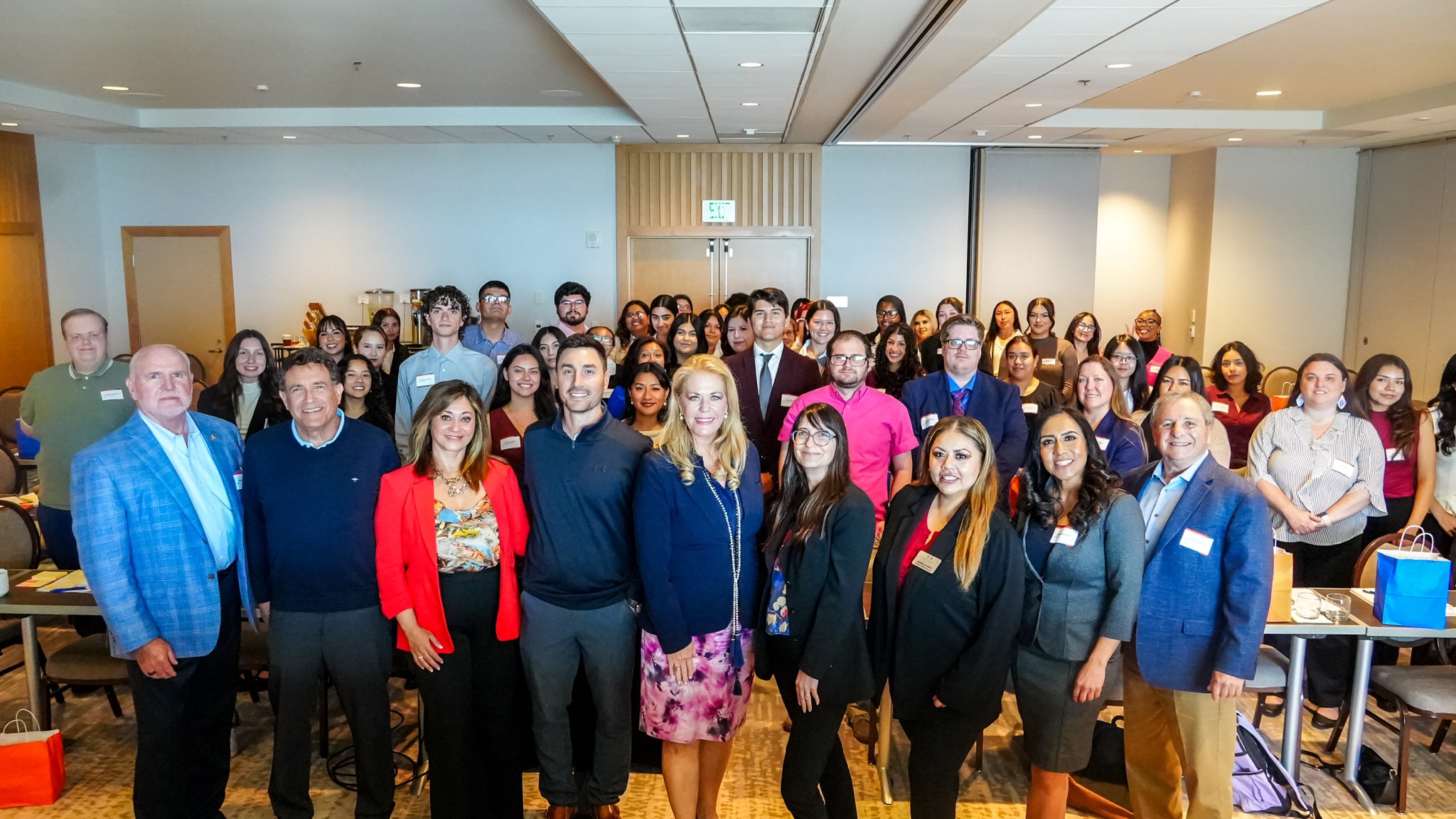 Jessica Stern, dean of the College of Humanities and Social Sciences, and Cherie Rolapp, director of the Passage to the Future program, pose for a group photo with students during Titans Reach Higher Weekend.