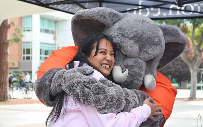Tuffy hugs a student at the HSS Pub Fest event.