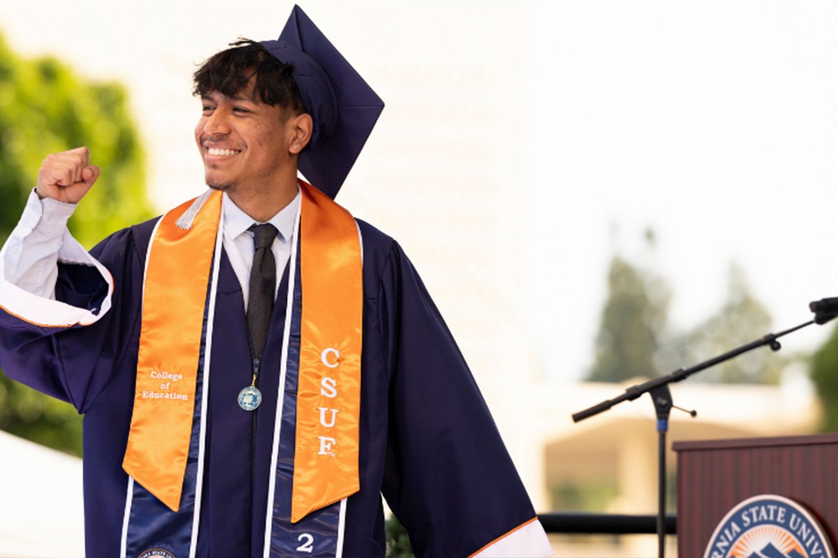 A CSUF graduate celebrates at commencement.