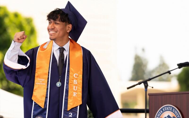 A CSUF graduate celebrates at commencement.